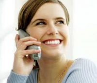 Smiling girl on the telephone providing Customer Service